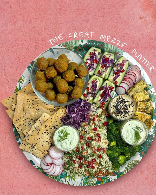 The Great Mezze Platter is a celebration of Mediterranean flavors. It features my green falafels, bright tabbouleh, crisp lavash, creamy hummus, and a refreshing dill olive sour cream, all ready to delight your guests.