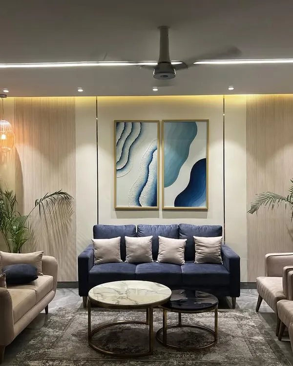 This living room in Jaypee Greens, Noida, embodies my design philosophy. I focused on creating a serene and sophisticated space using a neutral color palette with a bold blue sofa as the focal point, complemented by abstract art. The layout is designed for both relaxation and social gatherings, featuring comfortable seating and layered lighting to create a warm, inviting atmosphere.