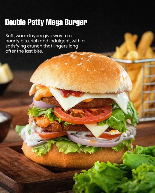 This is our Double Patty Mega Burger, and it's a real handful. We stack two of our signature pure veg patties with fresh lettuce, onions, tomatoes, and cheese in a soft bun. It's the perfect answer for when you're really hungry.