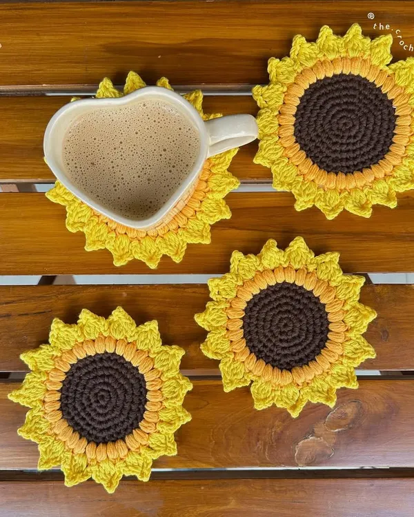 A cozy lifestyle shot of our handmade crochet sunflower coasters. These are perfect for adding a pop of color to your home decor or including in a gift hamper.