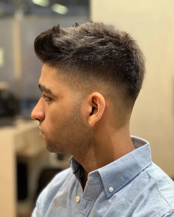 A crisp, sharp skin fade. This is a clean and modern look that requires precision and skill to execute perfectly.