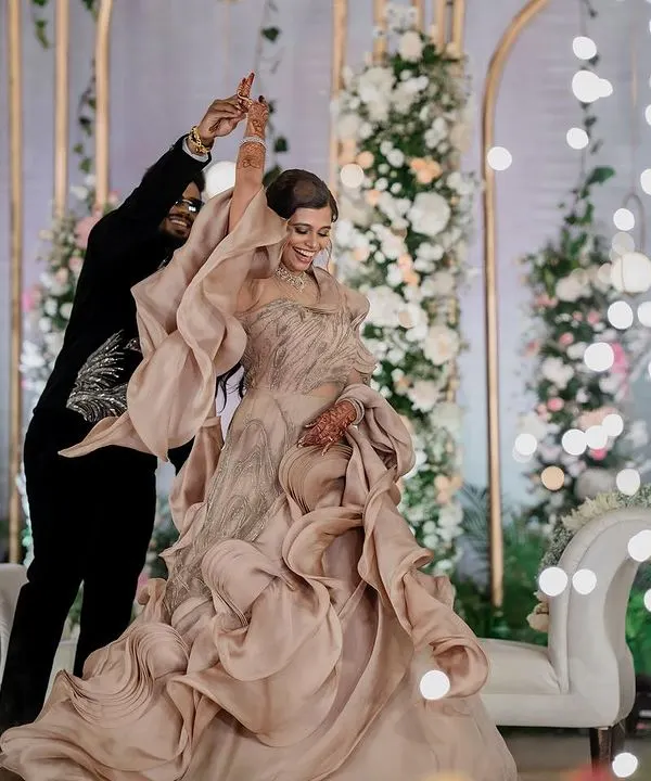 A magical first dance under a sky of sparklers. We use creative lighting and angles to make your reception moments, like this dance in a stunning Gaurav Gupta gown, look truly cinematic.