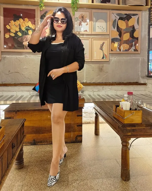A little black dress paired with a matching shrug and snakeskin-print heels creates a chic, sophisticated look. This is perfect for a business dinner or a professional networking event.