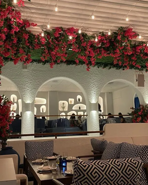 I transformed this restaurant's ceiling into a stunning floral canopy using vibrant, realistic artificial bougainvillea. This kind of large-scale installation creates an unforgettable ambiance for guests, making the space feel luxurious and inviting without any need for watering or upkeep.