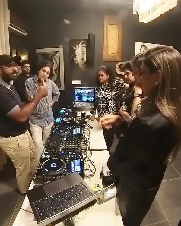 Here I am, leading a hands-on DJ training session for a corporate group. My workshops are all about getting you on the decks and learning by doing, no matter your skill level.