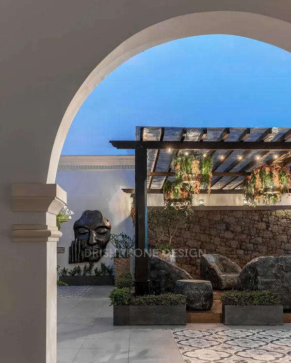 This is where the day ends and the evening begins. We designed this rooftop retreat as a serene escape, using dramatic lighting under the pergola to create a magical ambiance. The custom stone furniture and the gentle sound from the waterfall feature make it the perfect spot to unwind under the stars.
