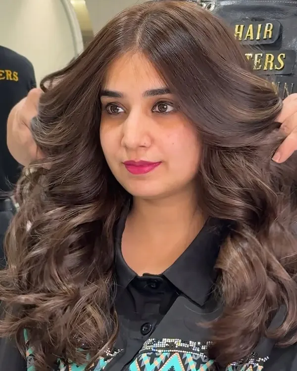 A beautiful mocha brown, achieved with zero bleach. Notice the volume, shine, and healthy texture of the hair after our coloring service.