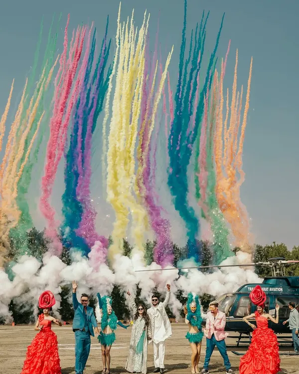 A grand arrival for a story written in the stars. With vibrant smoke trails painting the sky, the couple descends by helicopter, beginning their new chapter with a moment of pure cinematic magic. This is how I capture epic love stories.