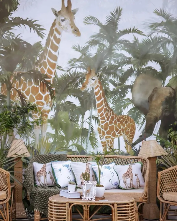 For Neomi and Rakshit's safari-themed sundowner, we created this immersive photo booth with a custom-printed jungle wallpaper. The rattan furniture and live plants made guests feel like they were in a luxe safari lodge.