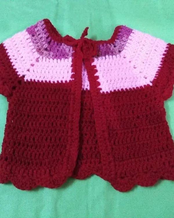 This adorable baby cardigan is a perfect project for beginners. You'll learn how to create the main body, shape the sleeves, and add a delicate scalloped edge, all using basic crochet stitches.