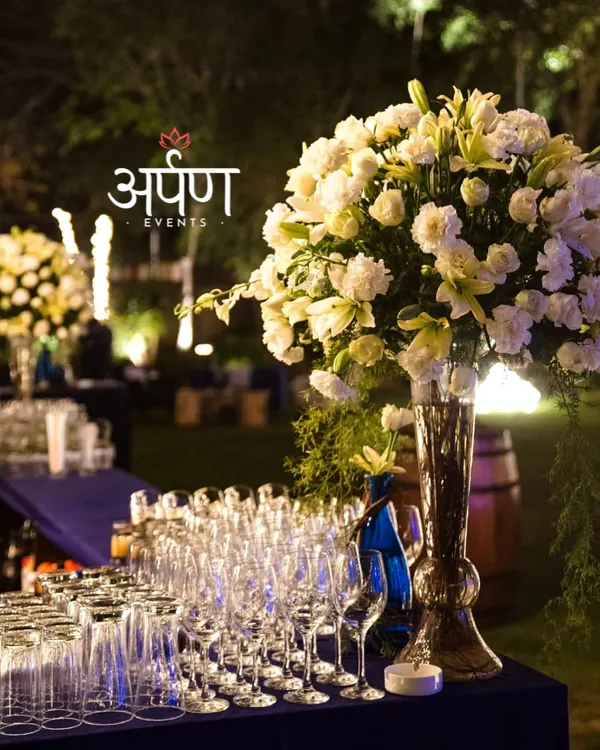 A close-up of a fully stocked and beautifully decorated bar for a large outdoor event. I provide a wide selection of high-quality glassware for wine, cocktails, and other beverages, ensuring every drink is served perfectly.