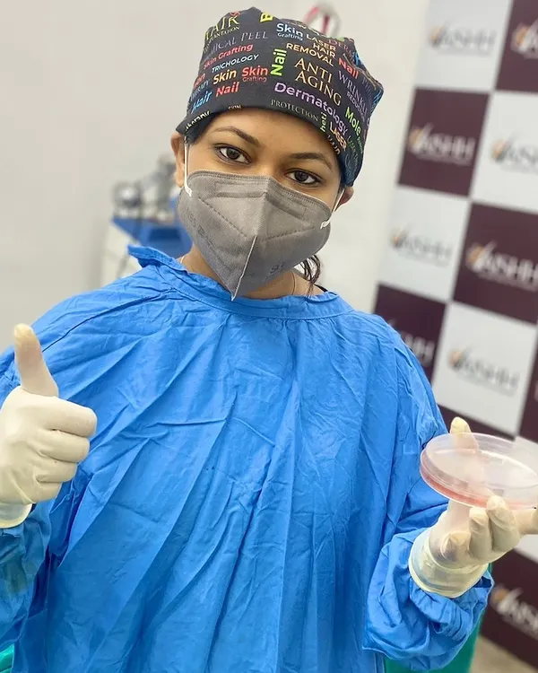 In my surgical gear, ready for a vitiligo procedure. The sample in the petri dish is part of a process where we transplant pigment-producing cells to the affected areas, encouraging repigmentation.