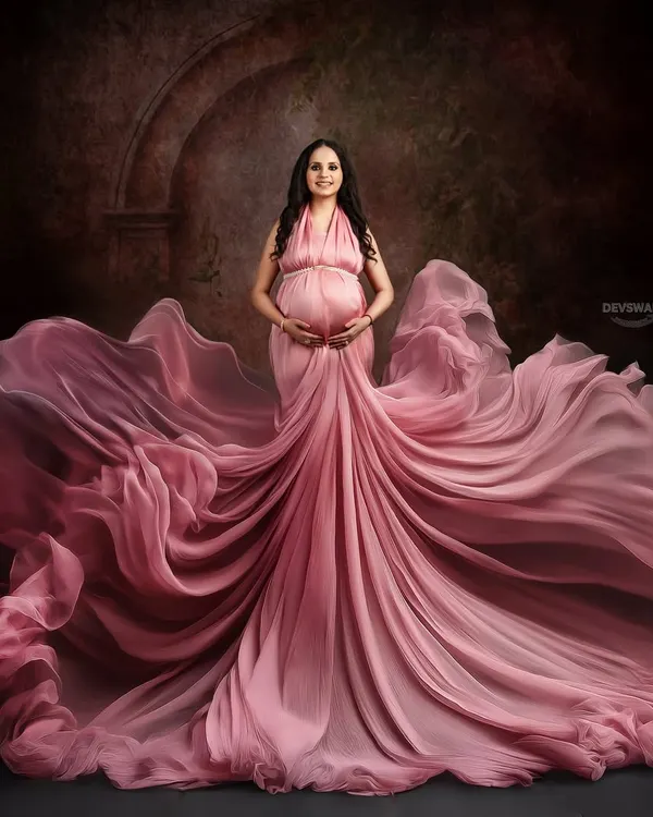 A dramatic portrait featuring a beautiful dusty rose gown with an incredible flowing train. I use fabric tossing techniques to create this sense of movement and grandeur against a painterly, textured backdrop.