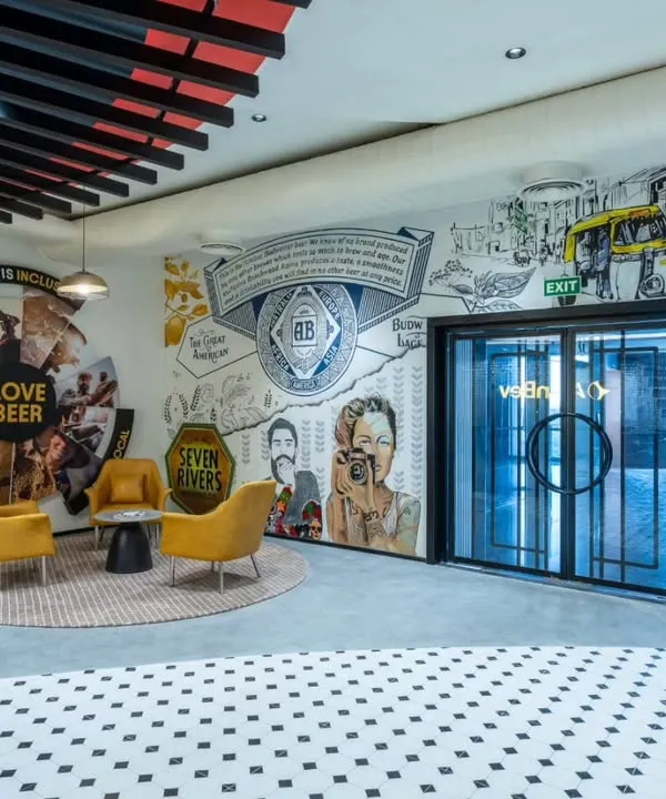 This reception mural for a major beverage company turns the first point of contact into an immersive brand experience. We used vibrant colors and dynamic illustrations inspired by the brand's Indian journey to create a space that is energetic, welcoming, and unforgettable.
