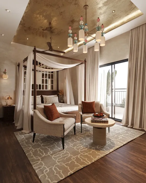 This bedroom is where earthy minimalism meets understated opulence. A four-poster bed is draped in soft, airy fabric, set against a backdrop of warm neutral textures. The delicate gold leaf design on the ceiling glows softly, adding a touch of richness without overpowering the serenity.