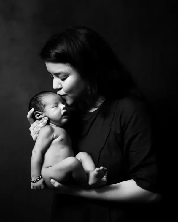 A mother's tender kiss for her newborn baby. These black and white portraits are so powerful, focusing purely on the emotion and connection in that moment.