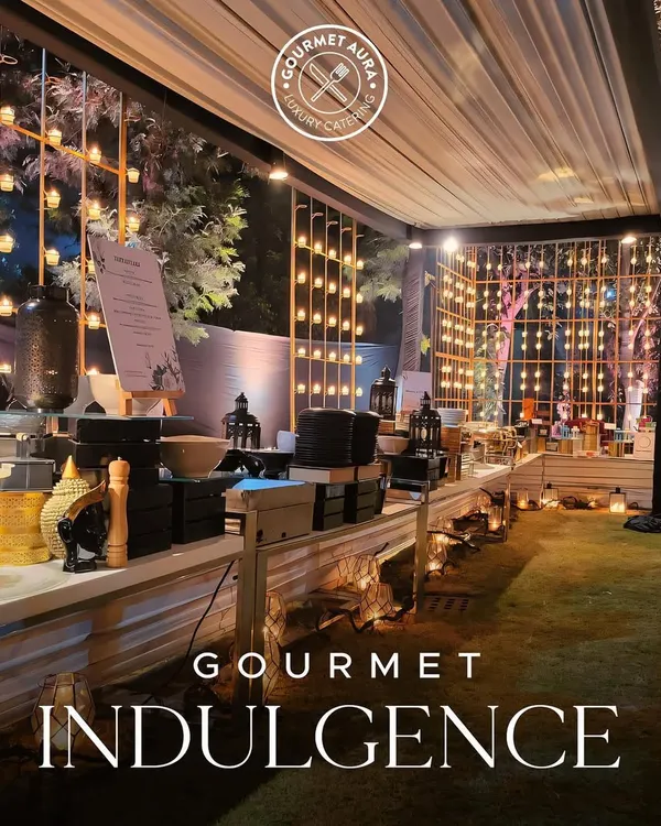 A stunning outdoor buffet setup at night, with warm lighting creating an inviting and magical atmosphere. This is gourmet indulgence on a grand scale.