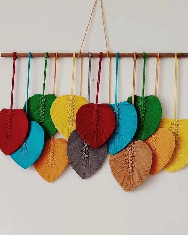 This custom macrame leaf wall hanging features a rainbow of vibrant colors. It's a beautiful and cheerful piece that can brighten up any room.