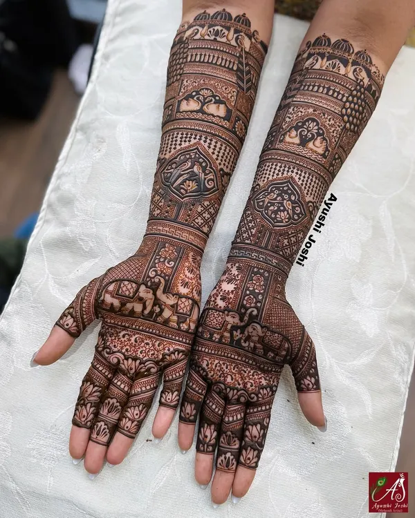 A classic and dense bridal design that is completely figure-free. It's filled with auspicious motifs like peacocks, elephants, parrots, and swans, woven into intricate patterns.