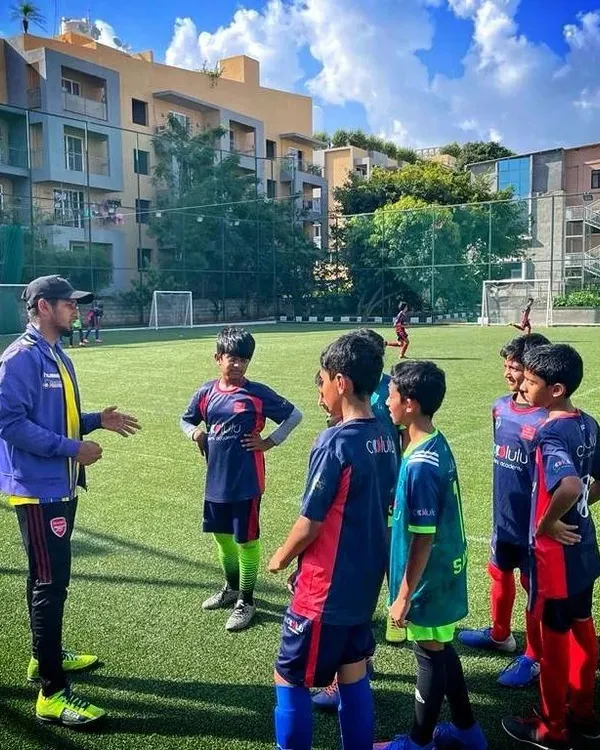 A coach discussing strategy with his team on the turf. We believe in empowering our players with the knowledge to make smart decisions during a match.