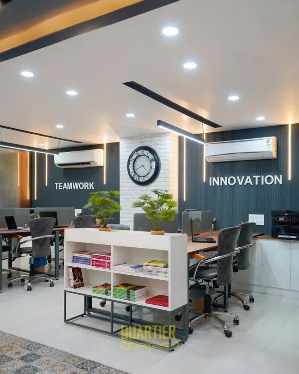 This professional workspace in Indirapuram is designed for productivity and motivation. We focused on creating a modern, energetic environment with custom metal-based workstations, strategic lighting, and bold wall branding that reinforces company values like "Teamwork" and "Innovation".
