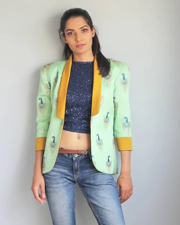 This is one of my favorite fusion looks, a perfect example of mixing East and West. I designed this power blazer with peacock embroidery and paired it with a sequin crop top and jeans for an instantly cool outfit. It’s a style that feels both bold and timeless.