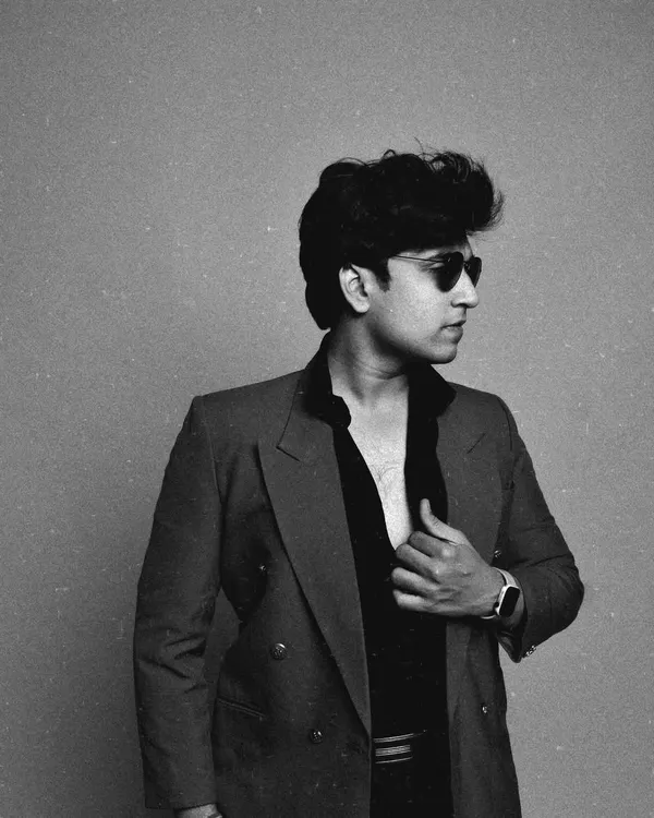 A black and white shot with a strong, classic feel. This demonstrates my ability to pull off a more intense, high-fashion look with a retro hairstyle and sunglasses.