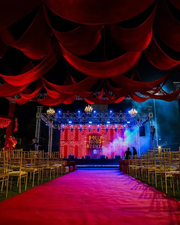 For a full-on filmy Sangeet, we created this Bollywood Night theme. The red carpet entrance, dramatic drapes, and retro bulb-lit stage made everyone feel like a superstar.
