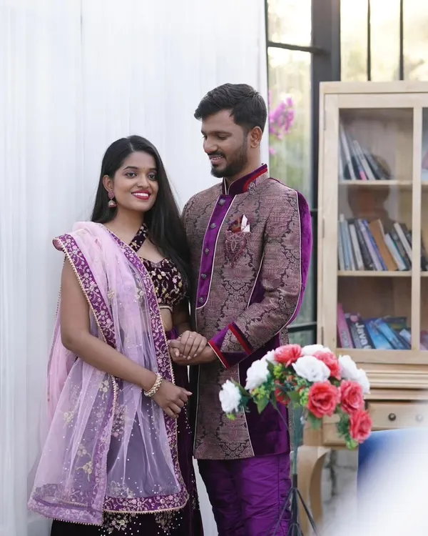 This is one of my coordinated ethnic wear sets, featuring a deep purple velvet lehenga with gold embroidery and a matching patterned sherwani. It's a perfect rental option for an elegant pre-wedding shoot.