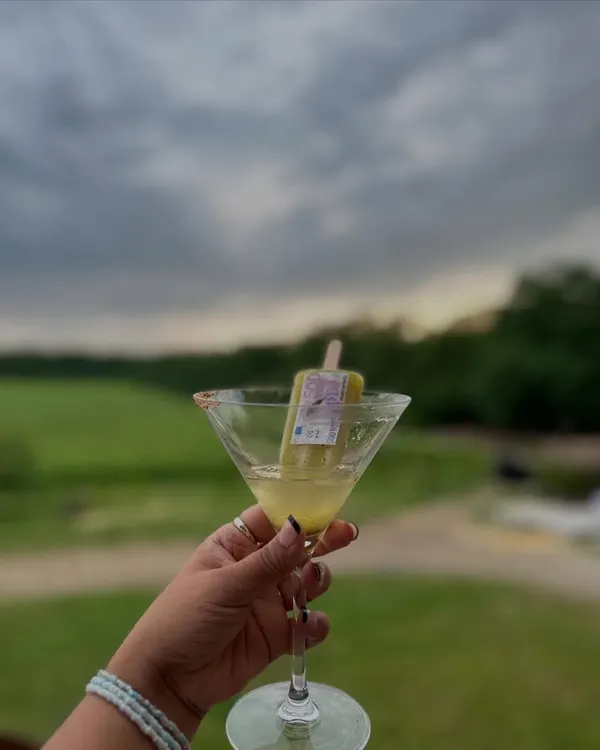 A refreshing popsicle cocktail served against the backdrop of a beautiful sunset. This was part of our exclusive bar service for a Hermès-themed sundowner, where every drink was designed to be as elegant and refreshing as the setting.