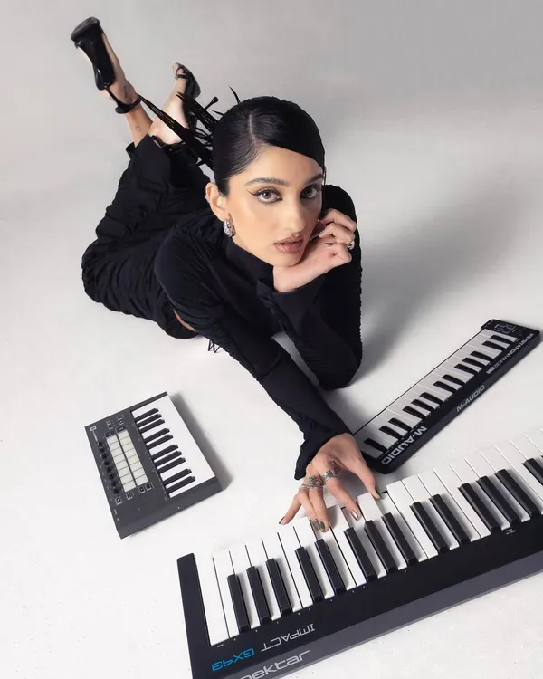 Here's me in my element, surrounded by the tools of the trade. I use a mix of keyboards and synths like the Nektar Impact and Novation Launchkey to find the perfect melody and build tracks from the ground up.
