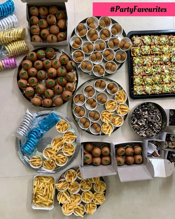 A beautiful spread of party favorites. This order included mini veggie burgers, corn & cheese balls, pizza on a cracker, french fries, and mini doughnuts.