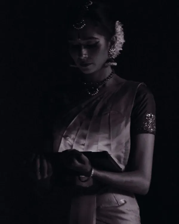 A quiet moment of reflection just before going on stage. The makeup is done, the costume is on, and the mind is focused. This is the calm before the energy of the performance is unleashed.