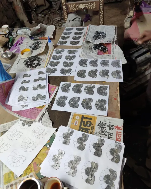 A work-in-progress shot of the Thikri glass panels, showing the individual components laid out on the design templates before being assembled.