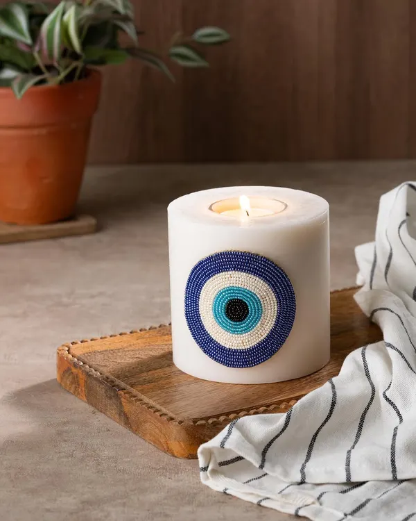 Ward off bad vibes with my evil eye candle. This large pillar candle features a beautiful, hand-beaded evil eye patch and can be used with a tea light, so you can cherish it forever.