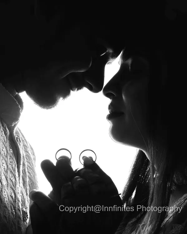 A creative black and white silhouette shot that beautifully incorporates the engagement rings, symbolizing the promise of a future together.