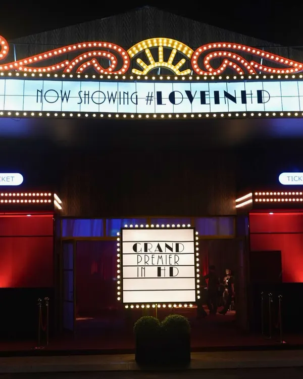 This is how we set the stage for a Sangeet with full Bollywood drama. We built a movie theatre entrance from scratch in Phú Quốc, Vietnam, complete with a lit-up marquee and red carpet, to make the couple's 'Grand Premier' a reality.