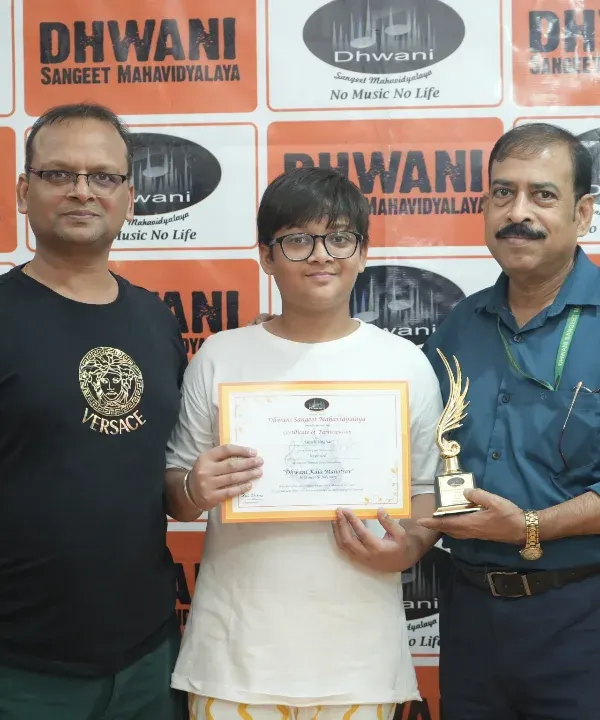 A proud student receiving his award for excellence in art, flanked by his father and our instructor. We celebrate every achievement as a milestone in the artistic journey.