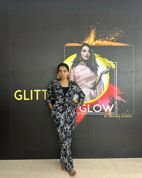 Standing proud next to my brand logo at my studio. This space was my creative hub, and while I'm transitioning away from a physical teaching space for now, my work as a makeup artist continues.
