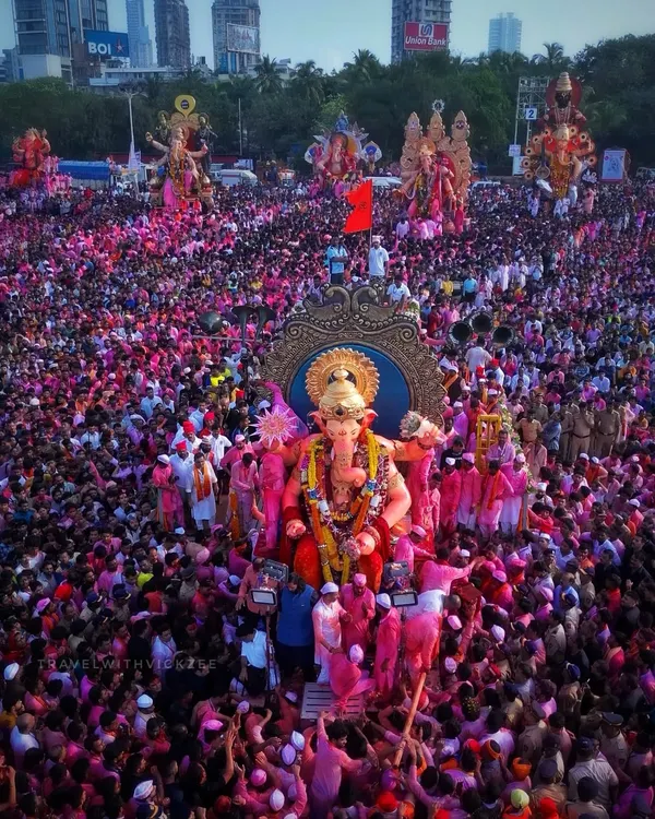 The iconic Lalbaughcha Raja Visarjan, where the idol is surrounded by a sea of pink turbans and outstretched hands. This is the peak of devotion and energy that I strive to capture.