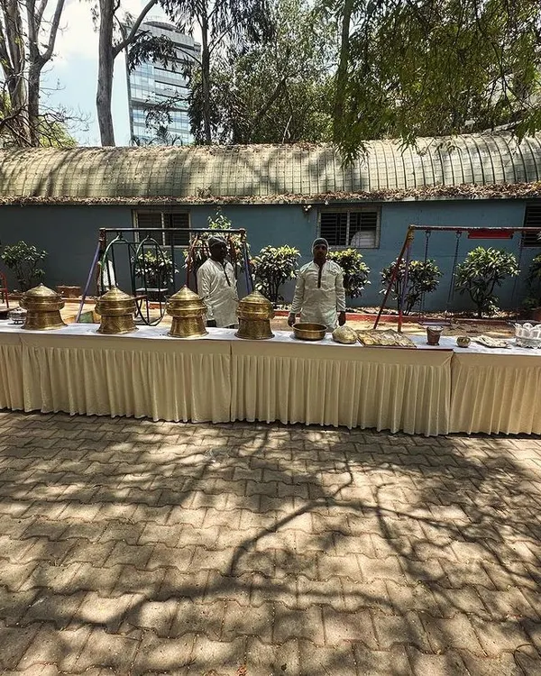 A full buffet setup for an outdoor event at Cubbon Park. Our elegant presentation includes traditional brass serving dishes to enhance the authentic dining experience.