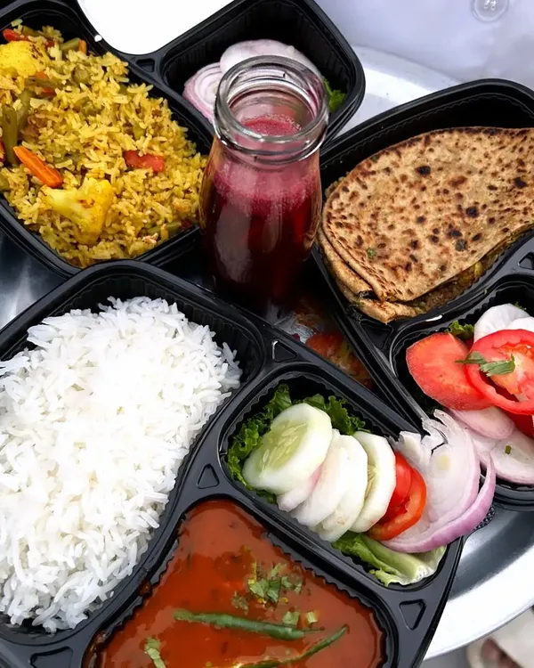 A look at the variety of wholesome North Indian meals I prepare. This spread includes vegetable pulao, a dal makhani rice combo, and a gobhi paratha meal, showing the different complete tiffin options you can enjoy.