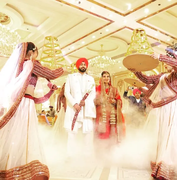 A spectacular entrance for the Sikh couple, complete with fog effects and traditional dancers. This is how you make a statement.