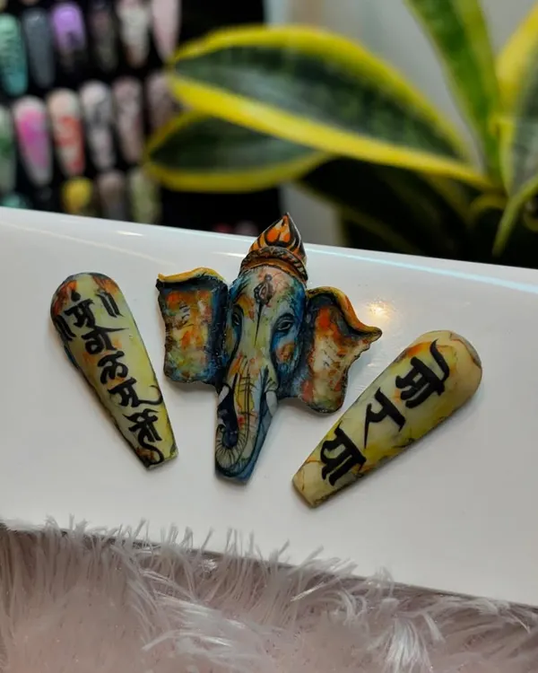 In celebration of Ganesh Chaturthi, we created this incredible 3D sculpted nail art of Lord Ganesha. The piece is accompanied by tips featuring hand-painted Sanskrit calligraphy, showcasing our deep respect for tradition and artistry.