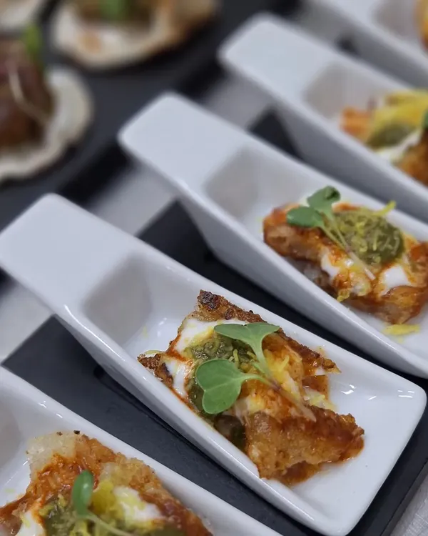An elegant start to any event. These single-serving spoons hold a savory bite topped with pesto and microgreens, designed for easy eating during cocktail hours and corporate mixers.