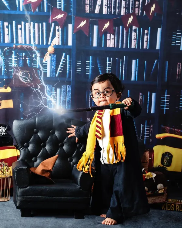 Wingardium Leviosa! For all the Potterheads, I offer a magical Harry Potter themed photoshoot. With a library backdrop, a Gryffindor scarf, and a magic wand, your little one can step right into the wizarding world.