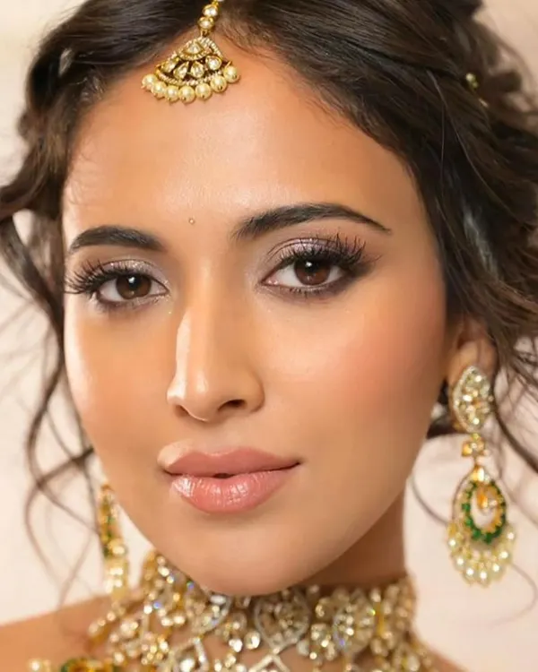 This is one of my signature bridal looks, combining a soft, glowing makeup application with a modern, textured updo. I focus on creating a look that is both elegant and feels personal to the bride.