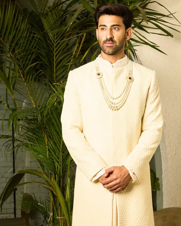 A full-length view of my classic off-white sherwani, tailored to perfection. The clean lines and premium, textured fabric offer a refined and regal look for the groom who values understated sophistication.