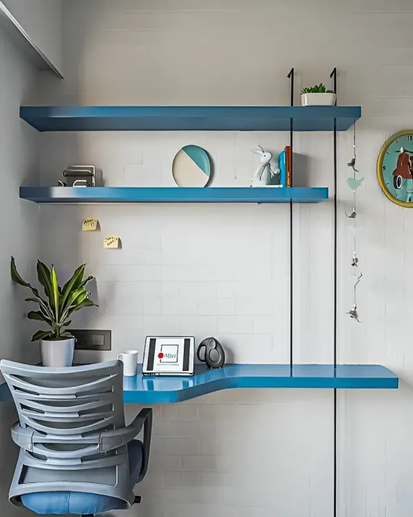 A minimalist floating study desk in a bright blue finish, with matching shelves above. This design is perfect for creating a stylish and functional work corner in a small space.