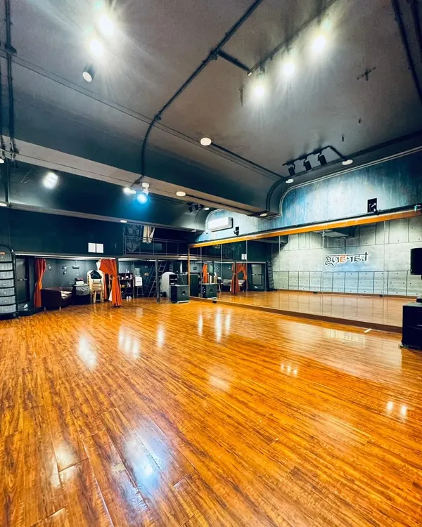 A wide view of our main dance hall. The space is designed to be open and versatile, perfect for choreographing large group numbers or intimate couple dances. The professional lighting and flooring help simulate a real stage environment during rehearsals.